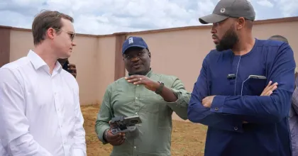 UN Volunteer, Dennis Bwala (center) speaks to representatives from the German Ministry of Foreign Affairs during a donor visit to the 152 houses built by UNDP in Jibia for the internally displaced persons. 