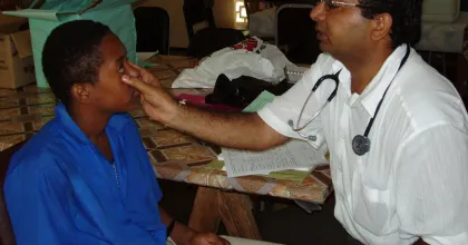 Former international UN Volunteer Doctor from India, Dr. Mukeshkumar Prajapati, photographed here while conducting a medical evaluation on an adolescent in Trinidad and Tobago in 2005.