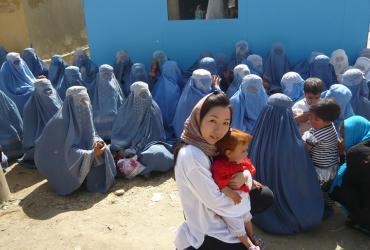Atsuko Hirakawa in front of the Independent Election Commission in Parwan, where Afghan women wait to receive a Voter’s ID card to vote in the Presidential and Provincial Council elections.