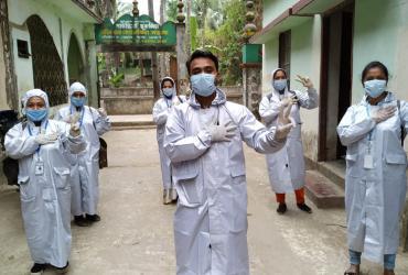 group-photo-of-UN-Community-Volunteers-wearing-PPE.jpg