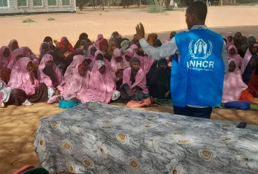 Adow Mohamed Ibrahim, UN Volunteer Youth Community Services Assistant with UNHCR, advocating for girls' education in Dagahaley Refugee Camp, Kenya, as part of the Youth Education Programme.