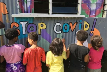 Youth painting a mural to raise awareness of COVID-19 in Vuniivi settlement Lami, Fiji.