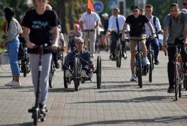Sasha Audzevich, centre, plans to tour the world on his handcycle, to raise awareness about inclusion of people with disabilities. 