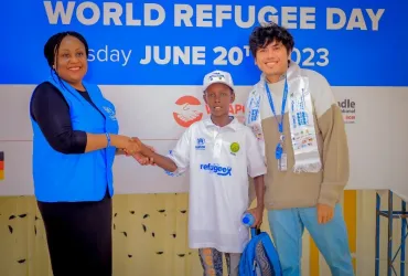 Denny Beryan Saputra, international UN Volunteer Specialist Associate Operational Data Management Officer (right) during a UNHCR organized art contest on World Refugee Day on 20 June 2023. The children showcased their creativity through the power of art to connect, empower, and inspire. 