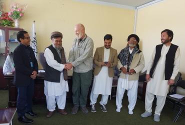 Barry Greville-Eyres (third from left), International UN Volunteer with UNDP shakes hands with the District Governor, Bamyan Province, Afghanistan.