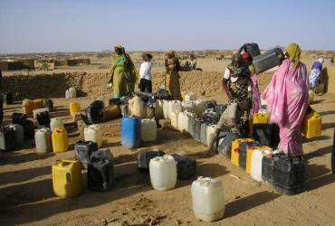 Sudanese refugee women prepare to fill their containers with precious water at a camp in eastern Chad.  