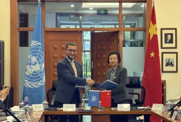 Ms. Ai Yinfang, Deputy Director General of CICETE, and Toily Kurbanov, Executive Coordinator of UNV, sign a Framework Agreement between UNV and the Government of China in Beijing on 14 October 2026.