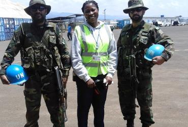 Aya Alice Kouakou (Côte d'Ivore) UN Volunteer Air Operations Assistant, with UN peacekeepers on the tarmac of Bukavu, Democratic Republic of Congo.