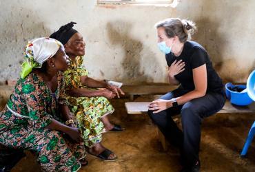 UN Volunteer Louise Gronmark, Political Affairs Officer and member of a multidisciplinary team from the Beni office, discusses the MONUSCO mandate with two women in the Eringeti area.