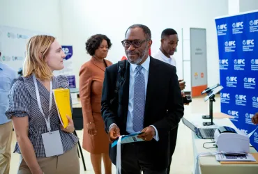 Alissa (left), UN Volunteer Operations Analyst with IFC, exchanges with a colleague during the Country Investment Review and Analysis (CIRA) dissemination event.