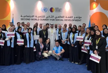 Toily Kurbanov, Executive Coordinator of UNV (front center), with UN Volunteers at the Second World Summit for Social Development in Doha.