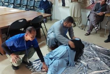  Dr Heri Suratno (left, wearing medical scrubs) is an international UN Volunteer Medical Doctor with the UN Assistance Mission in Afghanistan (UNAMA). Here, he delivers first training to UN personnel in Kandahar.