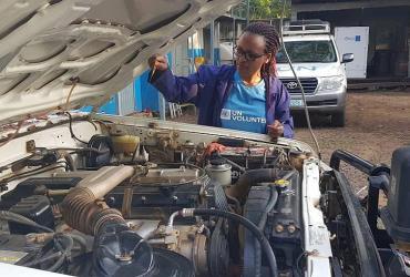 Amabel Nagaba, UN Volunteer Associate Fleet Management Officer, performing a pre-trip inspection for a vehicle going on a road mission.