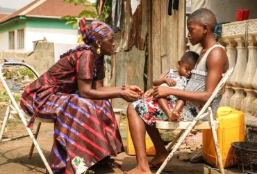 At 14, Dankay Kanu (right) got pregnant by an older man who refused to wear a condom then denied paternity. Though she quit school, she has since returned while raising her son, Ishmael, alone. "To be a mother at this age is really not easy," she said. 
