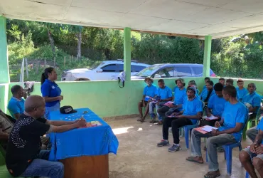 Fidelia Mendonca (standing), national UN Volunteer, Project Coordination Assistant with UNDP Timor Leste addresses the community in Ermera Municipality on services provided by the Spotlight Initiative including Access to Justice Clinic to support Domestic Violence and GBV survivors have access to the Formal Justice system. 