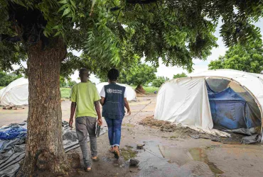 Veronica Mukhuna (right) is a UN Volunteer Communications Officer with the World Health Organization (WHO) in Malawi. She served on the frontlines of the cholera outbreak and cyclone Freddy response efforts and is seen here during a visit to Nkhata Bay District.