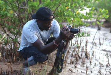 David Ouma, UN Volunteer Project Management Assistant, collects field stories for Nairobi Convention at Sabaki River, Kenya. 