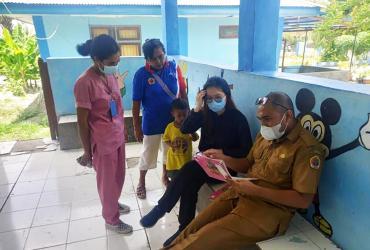 Rosyana Lievanty (second from right), national UN Volunteer Health Officer with UNICEF, checks documents at a public health center in Kupang District, Indonesia.