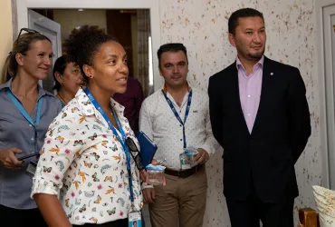 Toily KurbanovUNV Deputy Executive Coordinator Toily Kurbanov (right) and UNV Civil Engineer Gladys Gbegnedji (center-left) visit a newly rehabilitated home in Bartella, Iraq.
