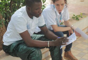 Irene Bronzini, an Italian UN Youth Volunteer fully funded by Belgium, preparing a presentation with her colleague, Lassane. (UNESCO/M. Blanco, 2017)