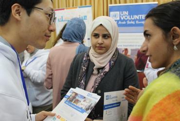 UN Volunteer Jongmin Weon (left) taking part in a student outreach activity for International Volunteer Day 2019 in Amman, Jordan.