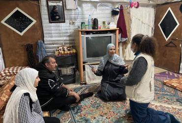 Noran Adly (Egypt), UN Volunteer Community Engagement Officer with UNICEF, visits a refugee family.