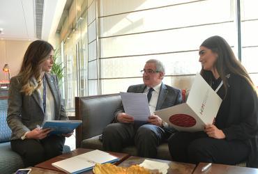 National UN Volunteers Vicky Kendirjian (left) and Lara Riachi (right) review with Minister of State for Women Affairs, Mr Jean Oghassabian