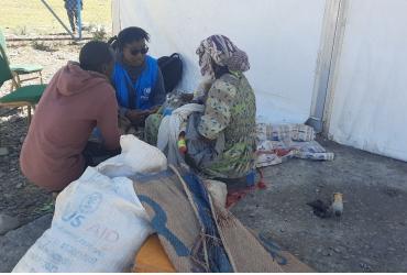 Lynn Karanja (in blue jacket), Associate Mental Health and Psychosocial Support Officer, UNHCR Ethiopia engages with a refugee woman in Alemwach Refugee Site to identify her needs and link her with the appropriate services. 