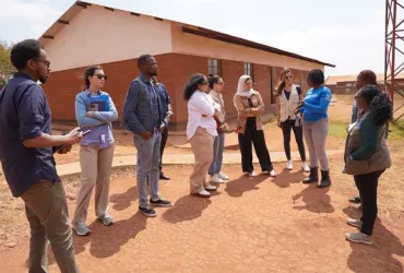 Zahra Vaziri (fourth from right), UN Volunteer Associate Programme Officer, during a field visit in Dzaleka Refugee Camp in Malawi. 