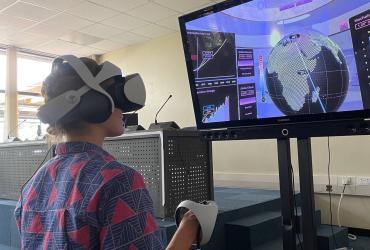 Polina Koroleva, international UN Volunteer Associate Programme Management Officer with Digital Transformation subprogramme trying the Virtual Reality (VR) Sony Climate Station at the UNEP Office in Nairobi, Kenya.