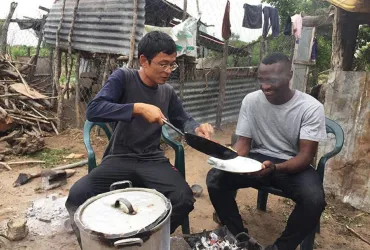 Volunteer Sompong Woragool (left), with the Friends from Thailand (FFt) Programme, learns how to make traditional food in Mozambique. 