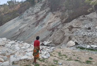 One of the victims, Shantu Maya Lama, looks at the remains of her house swept away by the floods.
