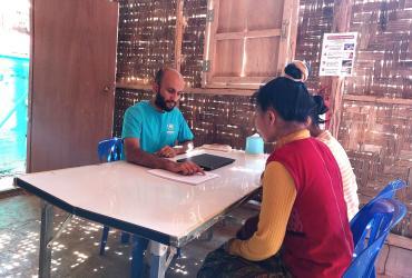 Nabin Thapaliya (left) international UN Volunteer with UNHCR Thailand Multi-Country Office provides resettlement counseling to refugees in Ban Mai Surin refugee camp in Mae Hong Son, Thailand.