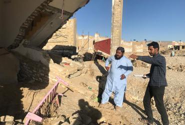 Former UN Volunteer Danish Murad (left) surveys people affected by the floods in Quetta for the district administration, documenting damage to homes and infrastructure. 