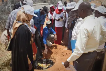 UNAMID UN Volunteer Abu Bakarr Bangura instructs youth group members from an Internally Displaced Person camp in Darfur on techniques for small scale composting