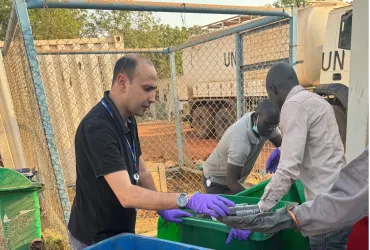 Bilel Dhouib (left) UN Volunteer Environmental Education Officer in a waste assessment exercise in UNMISS field location in South Sudan.