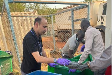 Bilel Dhouib (left) UN Volunteer Environmental Education Officer in a waste assessment exercise in UNMISS field location in South Sudan.