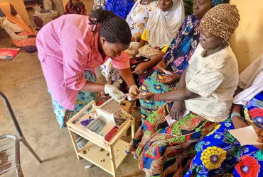 Elodie Toe, UN Volunteer Midwife with UNFPA, collects a blood sample for prenatal testing at the Salla Health Centre.