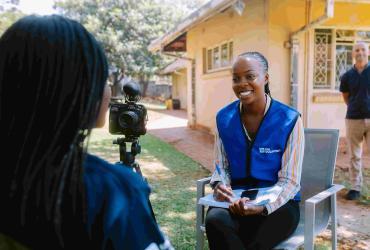 Rutendo Bamhare, UN Volunteer Communications Specialist with UNICEF interviews community members as part of her volunteer assignment. 