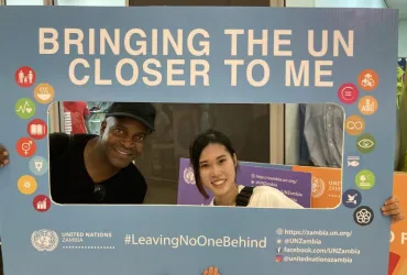 Moeka Sakamoto (left), UN Youth University Volunteer Communications Assistant with UNIC, and her supervisor, Mark Maseko, at a UN Job Fair in East Park Mall in Lusaka, Zambia.