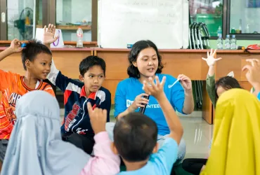Volunteers support well-being in communities. Photo from Indonesia referenced in the 2026 SWVR.