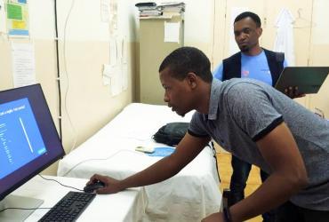 Alex Mkwamba, UN Volunteer Epidemiologist with UNDP, and Aleandro Ceita, a technician from the Health Information System department of the Ministry of Health, installing newly purchased computers at the Hospital Regional do Príncipe, São Tomé and Príncipe. 