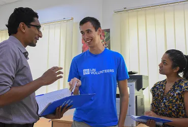 UN Volunteer Emergency Response Coordination Assistant, Alex Suwitra (Australia, centre) discussed humanitarian support in disaster situations with colleagues.