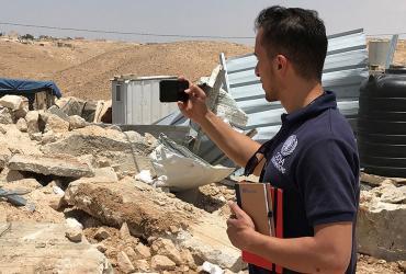 Abdelrahman Salayma, national UN Volunteer with OCHA in the State of Palestine, assessing a demolition site in Hebron. 