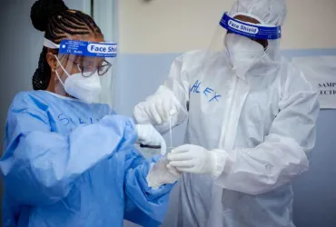 UN Volunteers Tabitha Shali (left), Nursing Officer, and Alex Munguti, Laboratory Technologist, prepare COVID-19 swabs for laboratory processing and analysis at Moi Referral Hospital, Voi, Taita Taveta County.