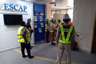 Susan Kihuga (first far left) with Seismic Mitigation Project personnel and contractors during a weekly safety walk to the construction site on 20 January 2022 at ESCAP.