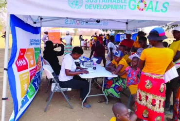 UNDP Zimbabwe staff and volunteers interact with community members during field visit to Mbire district in northern Zimbabwe.