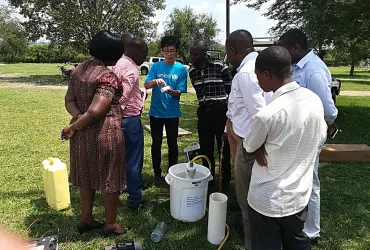 UN Volunteer Hodaka Kosugi provided technical support to health workers to disinfect water using chlorine solutions for Ebola infection prevention and control in Ntroko District, Uganda.