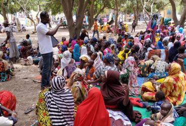 Volunteers in communities create positive change through people-to-people connections. Here, UN Community Volunteer Labbo Ladan Annour with UNDP raises awareness about gender-based violence in communities in Chad.