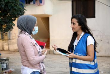La Volontaires des Nations Unies, Nagham Abou Hamdan (à droite), discute du suivi sur le terrain avec un enquêteur du PAM à Bebnine, au nord du Liban.